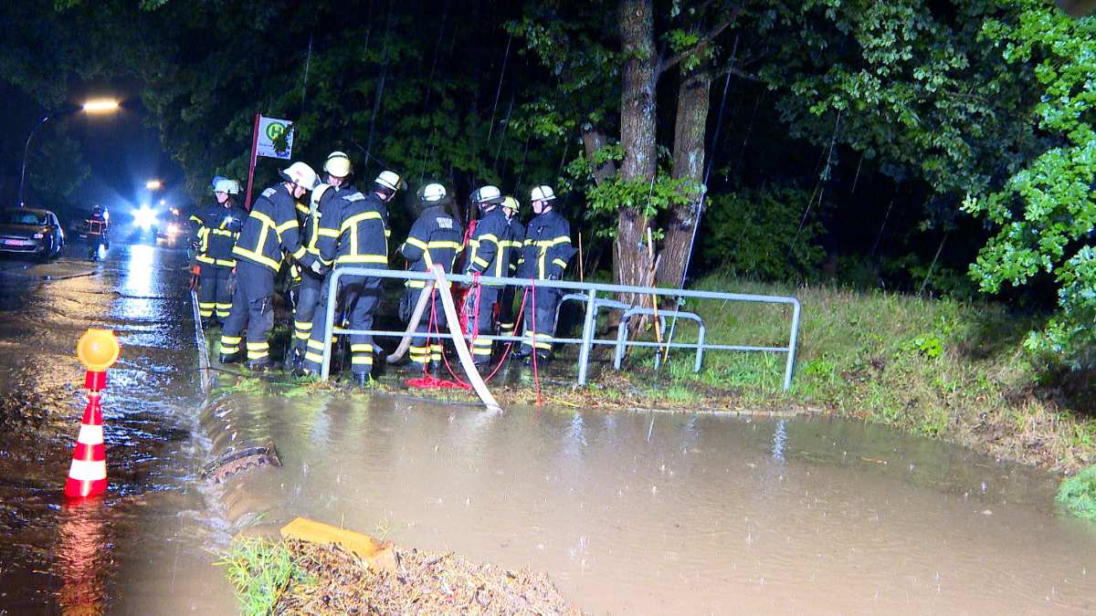 a group of firefighters standing near a metal railing