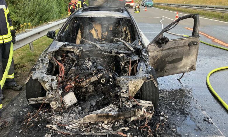 a burned out car on a road