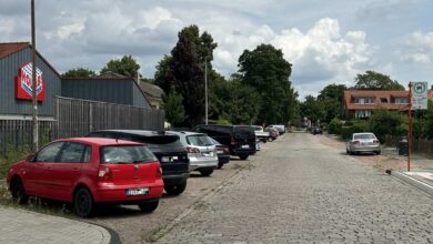 a row of cars parked on a brick road