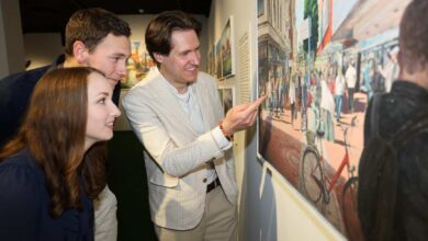 a group of people looking at a painting