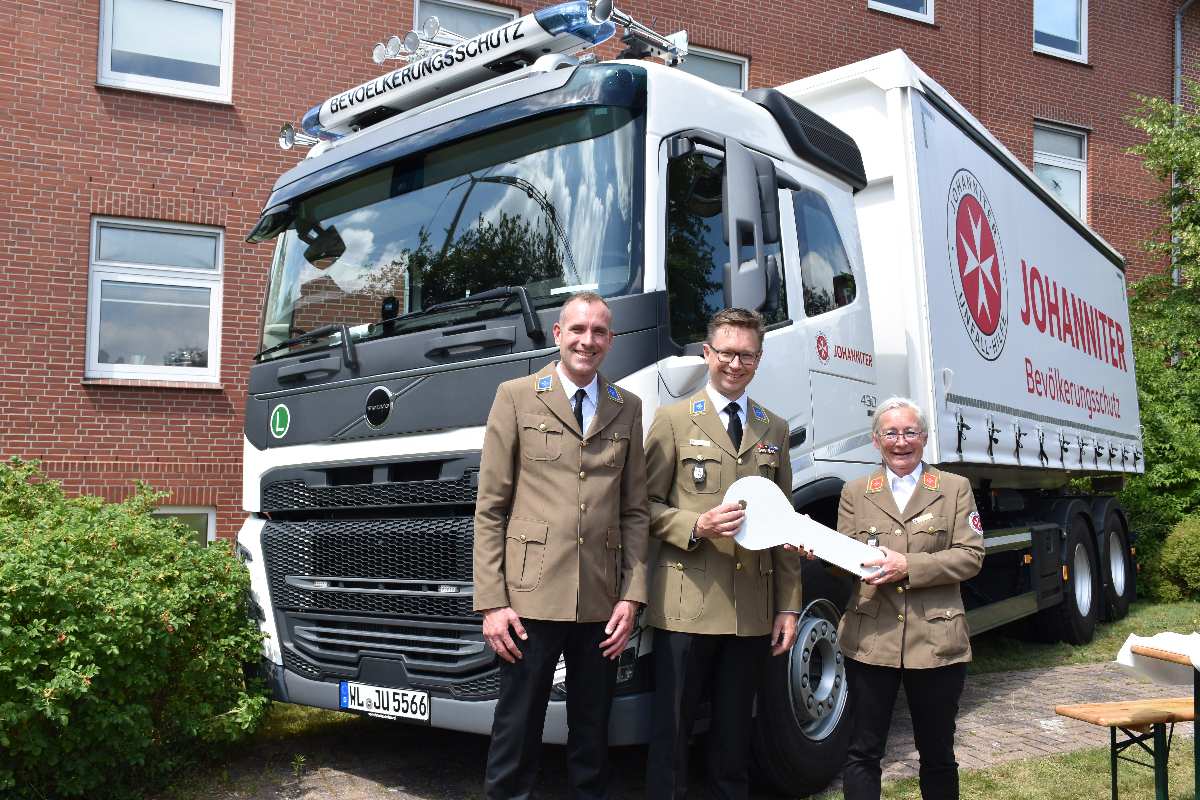 a group of people standing in front of a truck