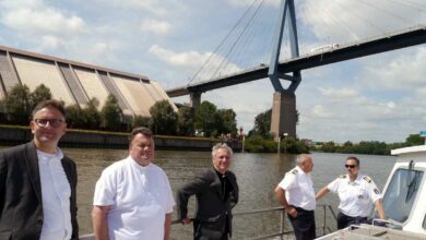 a group of men standing on a boat