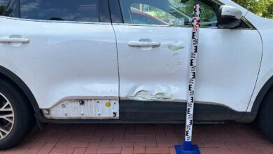 a white car with a white bumper and a white pole