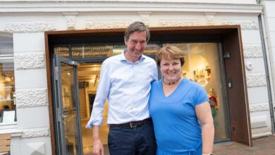 a man and woman standing in front of a museum