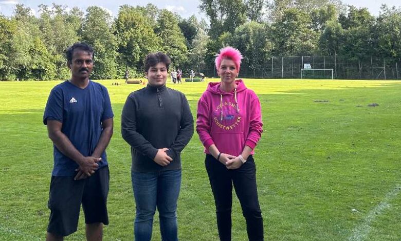 a group of people standing on a football field