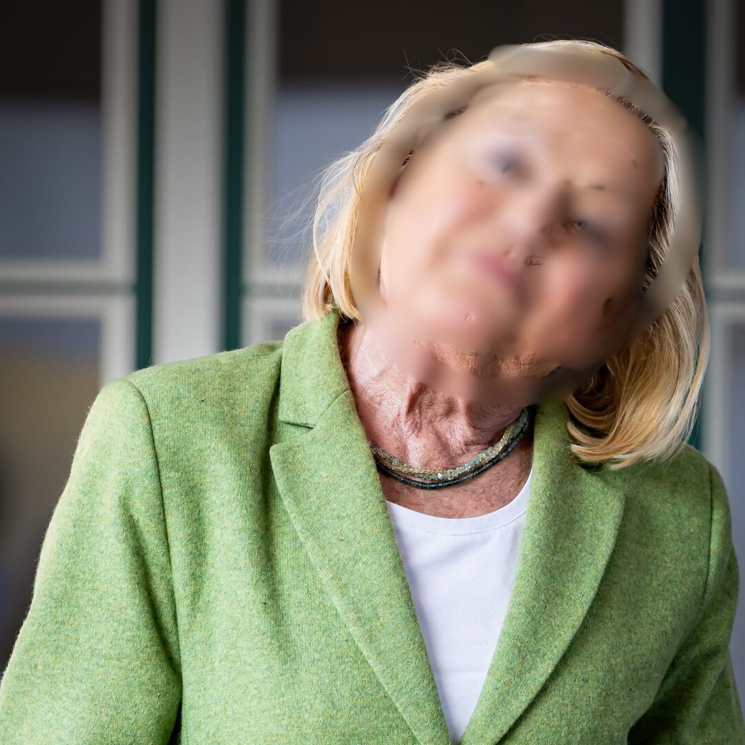 a woman in a green suit