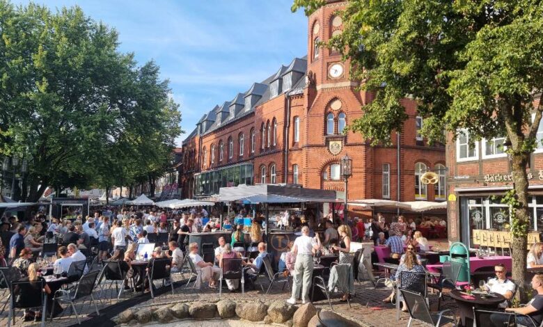 a group of people sitting at tables outside a building