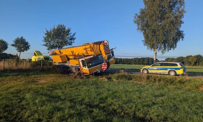 a yellow truck crashed into a car on the side of the road