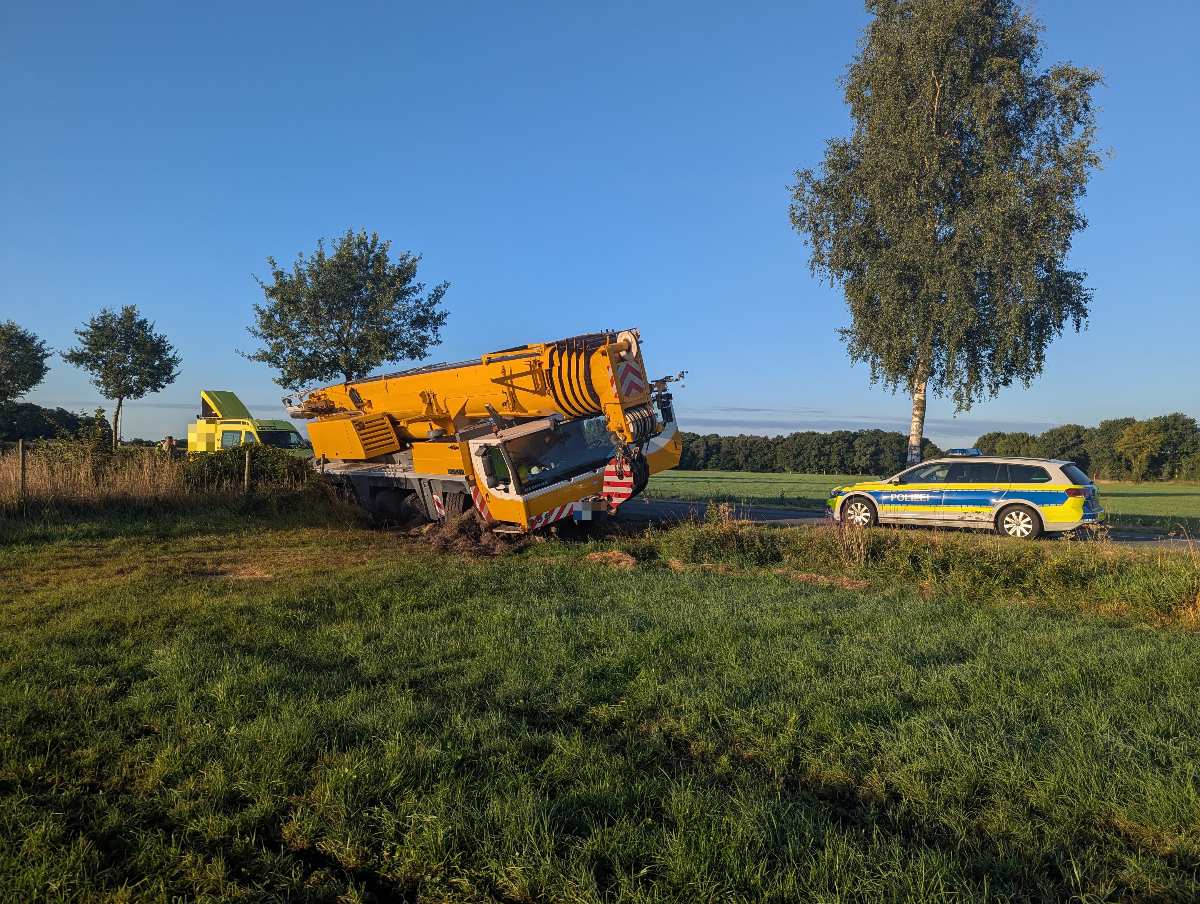 a yellow truck crashed into a car on the side of the road