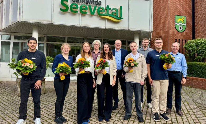 a group of people posing for a photo in front of a building