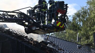 firefighters on a roof