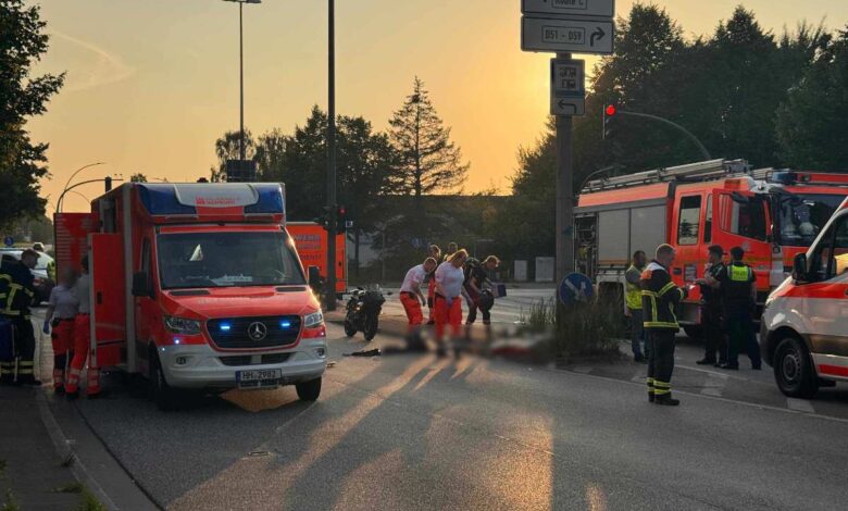 a group of people standing next to a motorcycle