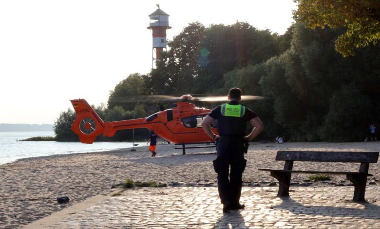 a man standing on a brick path near a helicopter