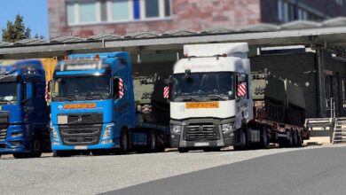 a group of semi trucks parked next to each other