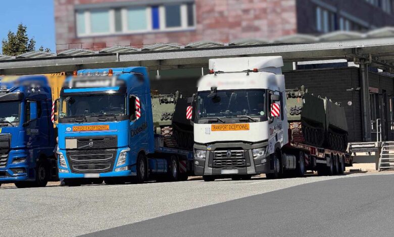 a group of semi trucks parked next to each other