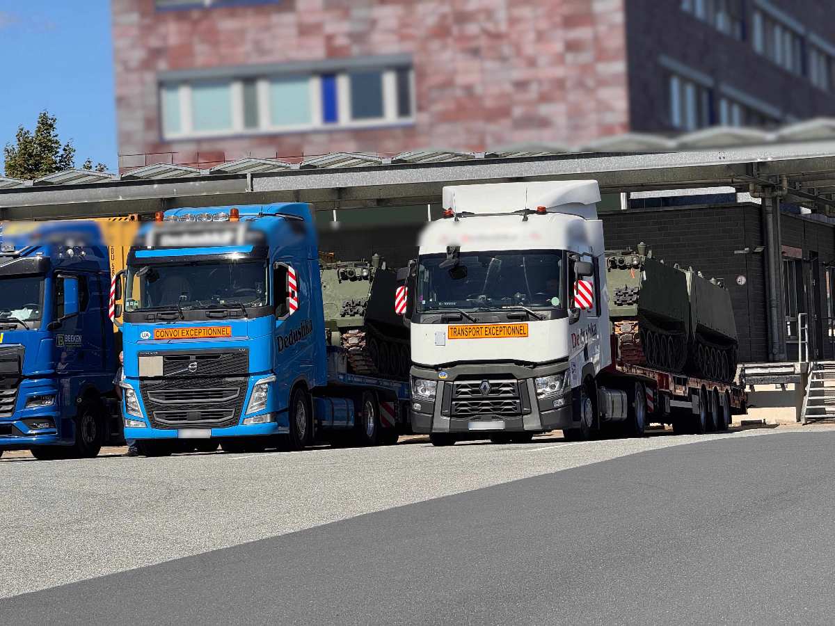 a group of semi trucks parked next to each other