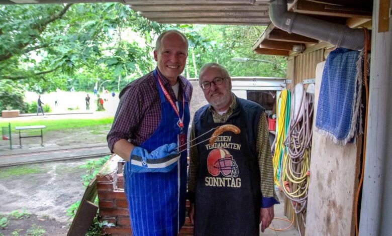 two men standing under a roof