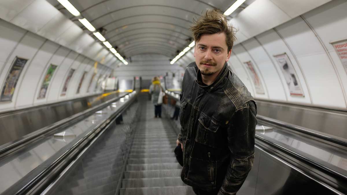 a man standing on an escalator