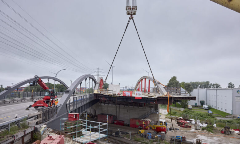 a crane lifting a bridge over a road