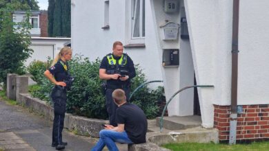 a group of police officers standing outside a house
