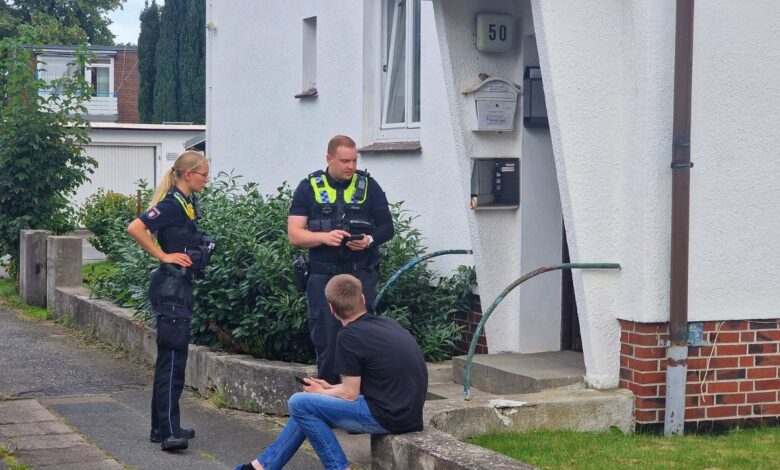 a group of police officers standing outside a house