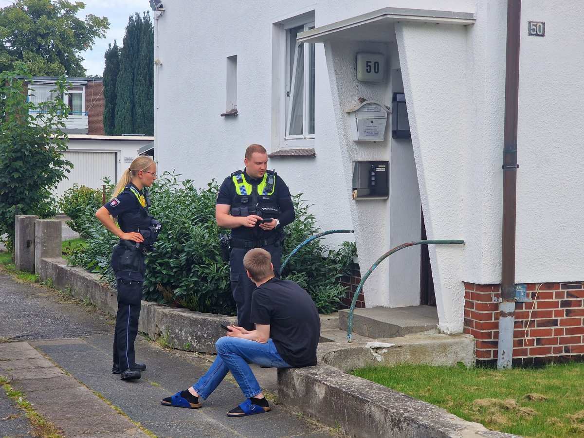 a group of police officers standing outside a house