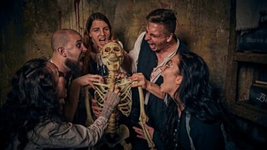 a group of people holding a skeleton