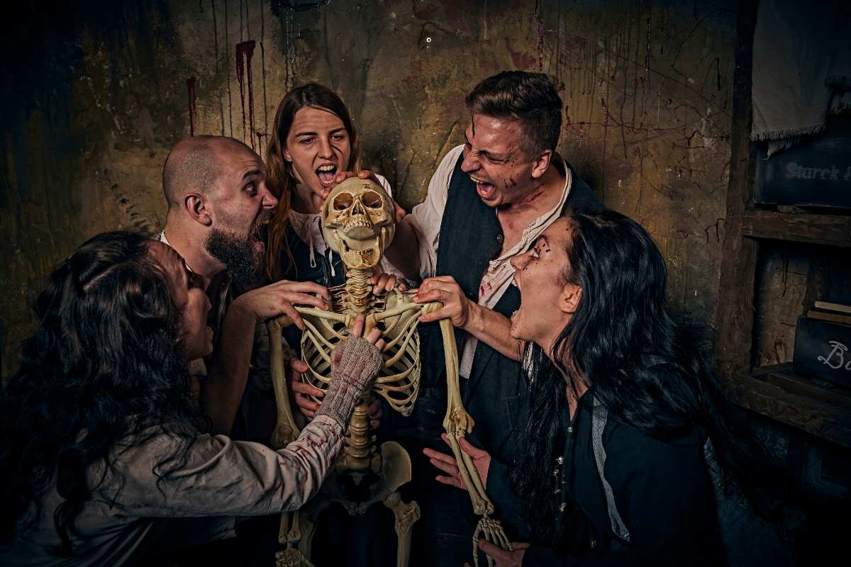 a group of people holding a skeleton