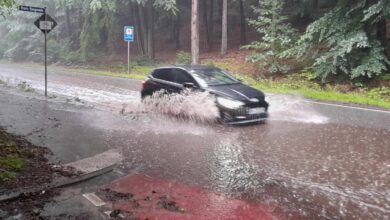 a car driving through water on a road