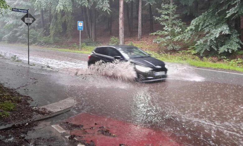 a car driving through water on a road