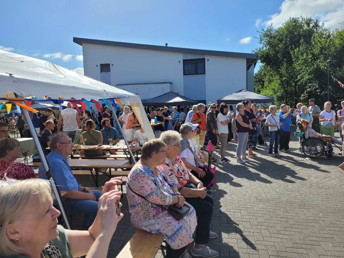 a group of people sitting on benches outside