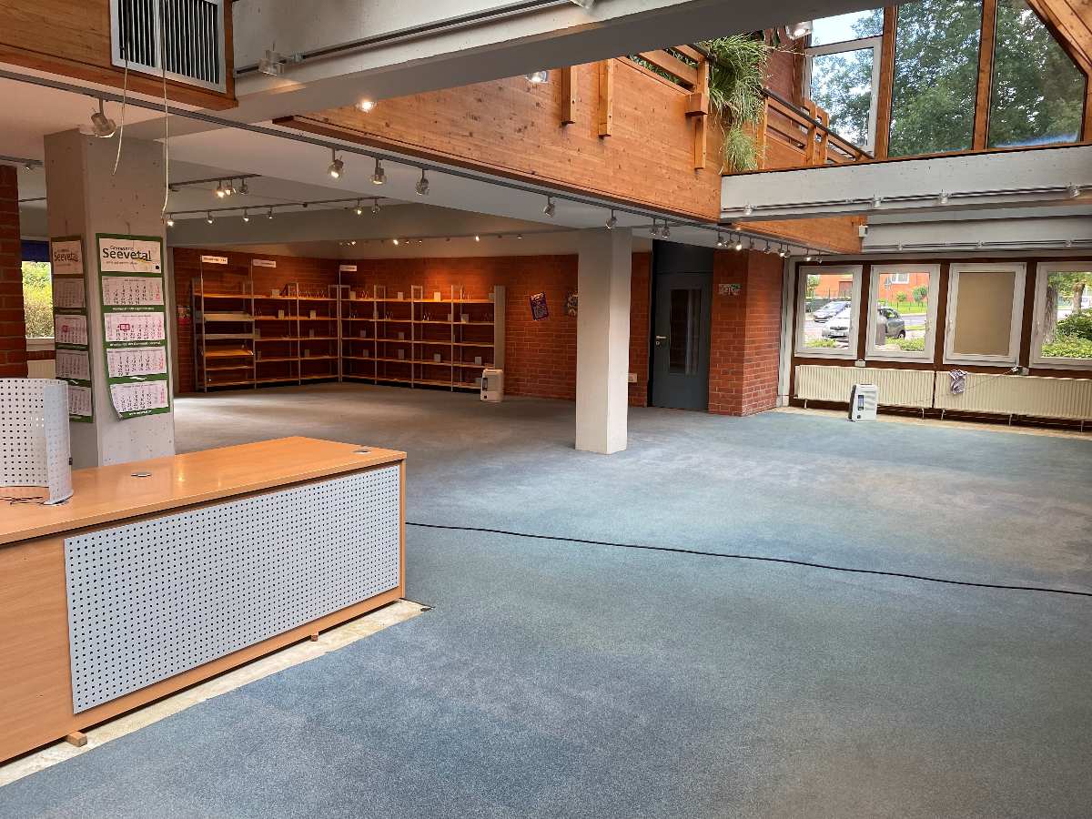 a room with a large window and shelves