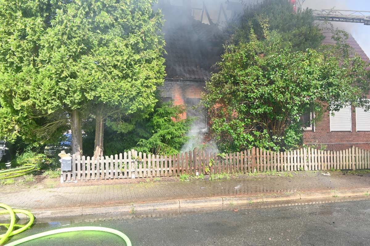 a house with a fence and trees