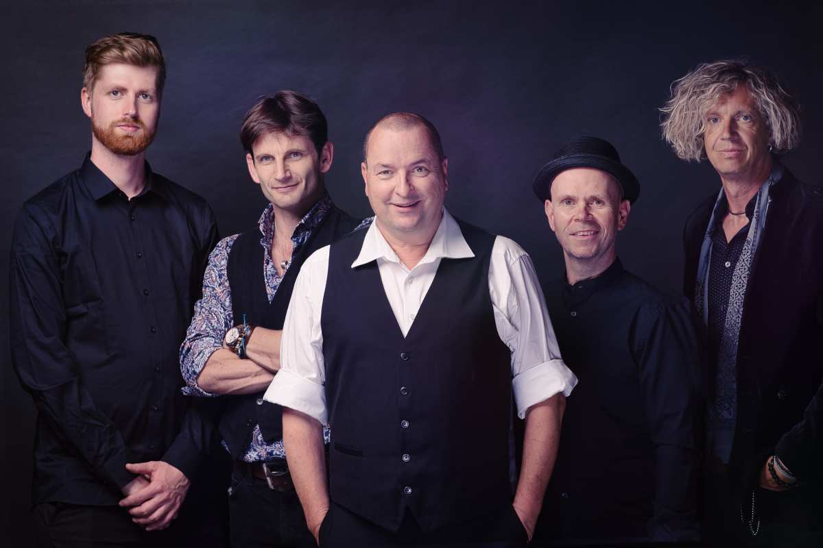 a group of men posing for a photo
