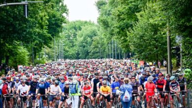 a large group of people riding bicycles on a street
