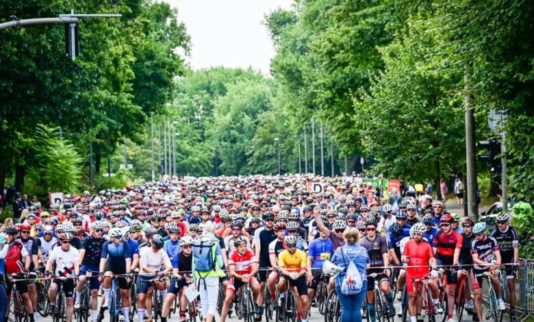 a large group of people riding bicycles on a street