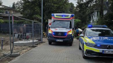 a ambulance and police cars on a street