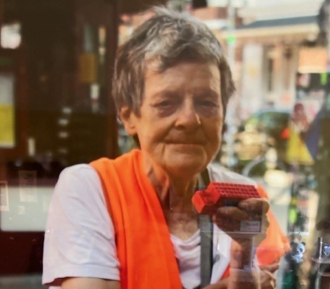 Person mit orangefarbener Weste und Spielzeug