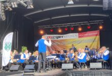 Blasorchester spielt auf der Bühne.