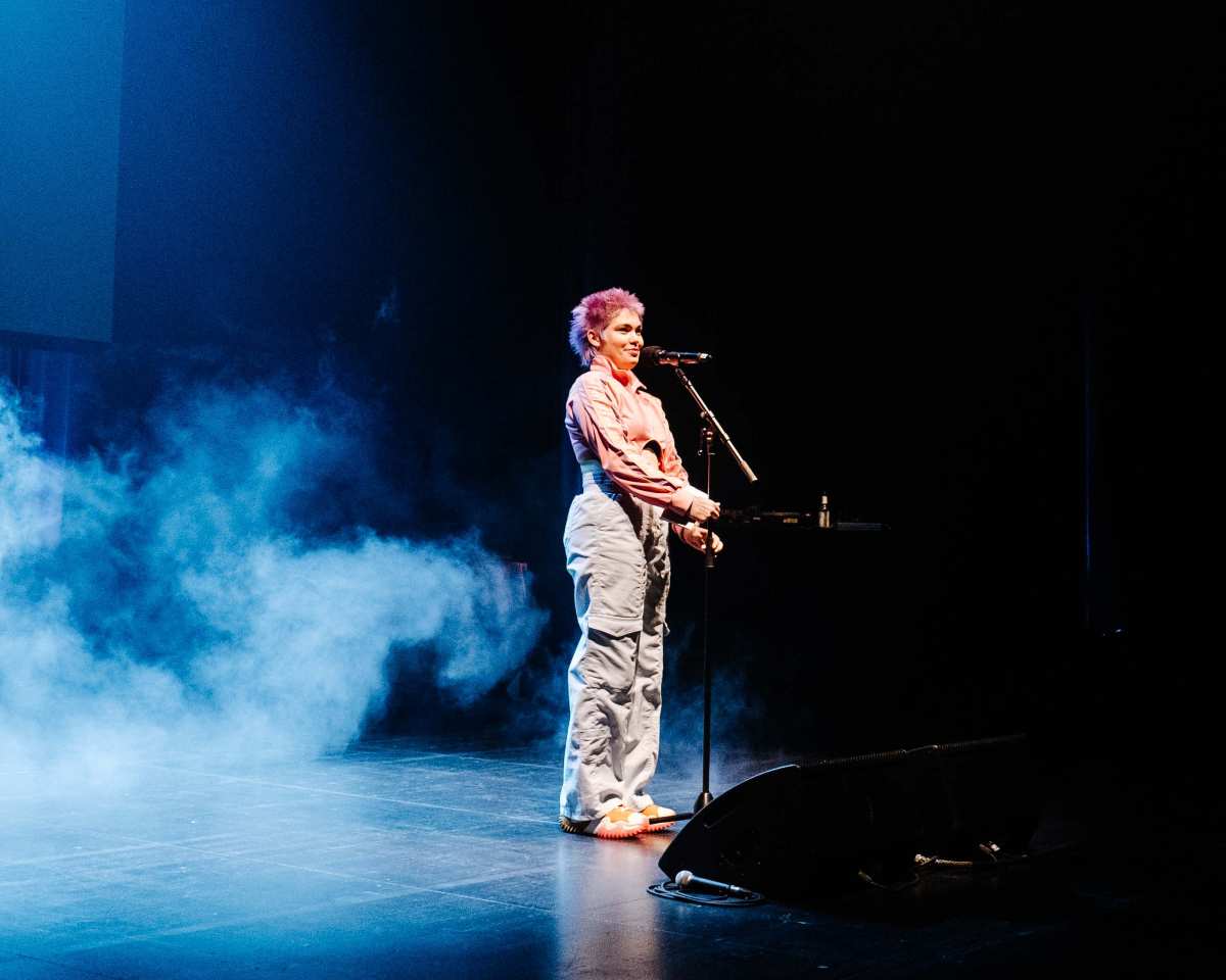 Eine Poetin spricht am Mikrofon.