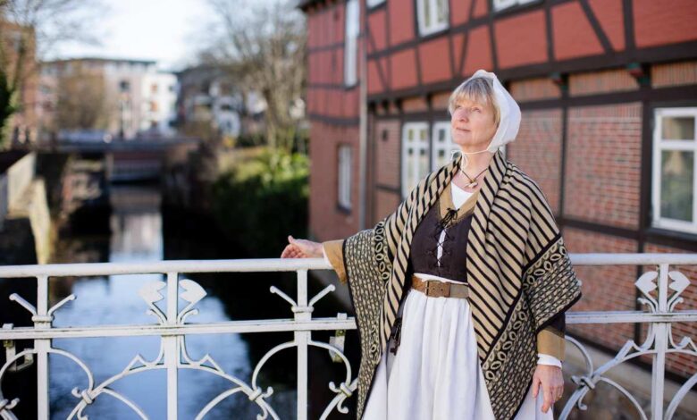 Buxtehude lädt im November zu Stadtführungen und spannenden Themenrundgängen durch Geschichte und Kultur 3 Frau in historischer Kleidung am Wasser.