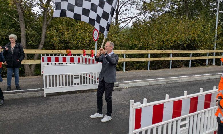 Mann mit Schachbrettflagge an Strecke