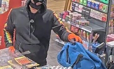 Maskierter Dieb im Geschäft